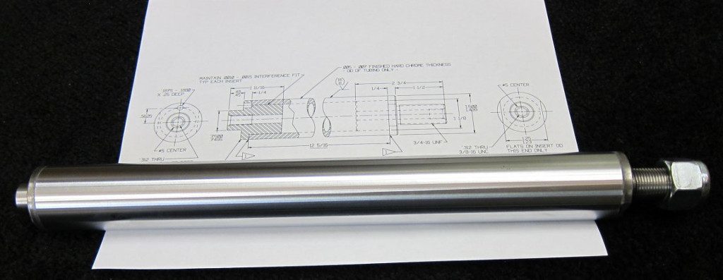 Piston from linear actuator repaired by hard chrome plating, shop drawing in the background