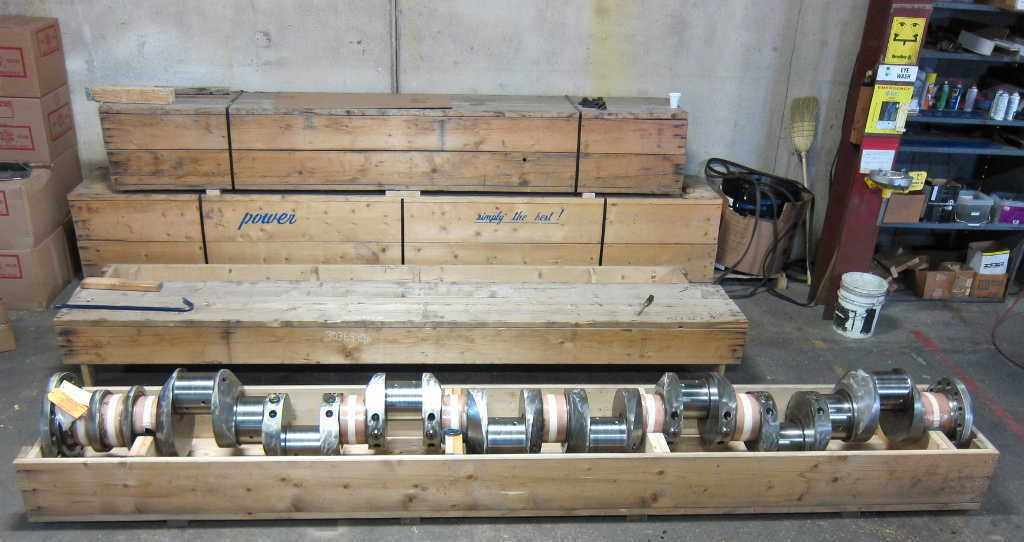 Waukesha crankshaft, 16V_AT-25, within crate inside of warehouse